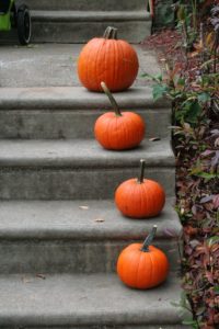 Pumpkins on the steps of a house